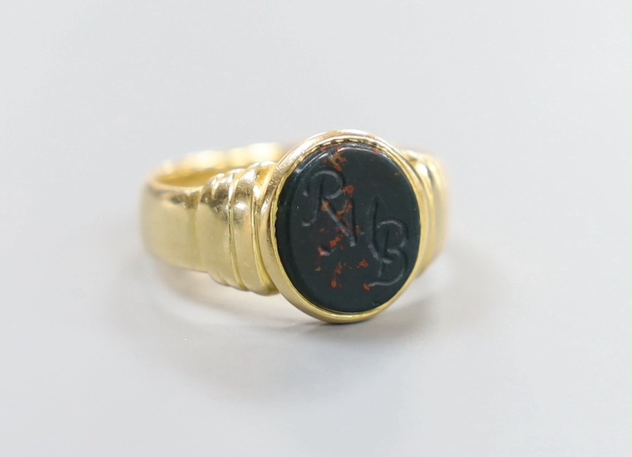 A George V 18ct gold and bloodstone set signet ring, the stone with engraved initials, size M, gross 6.3 grams.